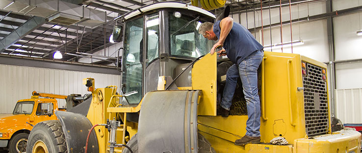 Technician servicing a wheel loader